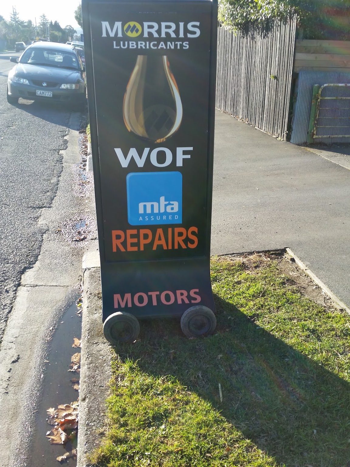The West Belt Motors roadside sign: Morris Lubricants, WOF, MTA Assured, Repairs, Motors